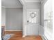 Bright entryway featuring wood floors, wainscoting, and a front door with decorative glass at 734 Hornchurch Loop, Cary, NC 27519