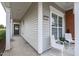 Inviting front porch featuring seating and a view of the home's exterior details, including windows and siding at 734 Hornchurch Loop, Cary, NC 27519