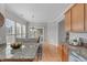 Open floor plan with eat-in kitchen, granite counters, and stainless steel appliances at 734 Hornchurch Loop, Cary, NC 27519