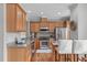 Open kitchen with stainless steel appliances, granite countertops, and ample maple cabinetry at 734 Hornchurch Loop, Cary, NC 27519