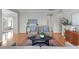 Comfortable living room featuring hardwood floors, two chairs, a sofa, and a decorative rug at 734 Hornchurch Loop, Cary, NC 27519