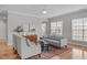 Cozy living room with hardwood floors, neutral seating, and stylish decor at 734 Hornchurch Loop, Cary, NC 27519