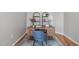 Stylish home office space with wood desk, shelves, blue chair, and area rug at 734 Hornchurch Loop, Cary, NC 27519