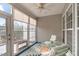 Inviting sunroom with comfortable seating, ceiling fan, and large windows, perfect for relaxation at 734 Hornchurch Loop, Cary, NC 27519