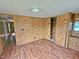 Bedroom features wood floors, wood paneled walls, closet and vanity space at 8025 Hebron Church Rd, Garner, NC 27529