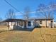 Back view of home with sunroom, patio, and shed at 8025 Hebron Church Rd, Garner, NC 27529