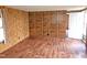 View of the wood paneled living room with laminate flooring at 8025 Hebron Church Rd, Garner, NC 27529