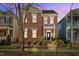 Charming brick two-story home with a balcony, lush landscaping, and a welcoming front entrance at 805 Historian St, Raleigh, NC 27603