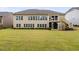 Large grassy backyard with well-maintained lawn and view of the two-story home and upper level deck at 832 Mountain Vista Ln, Cary, NC 27519