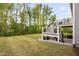 Spacious backyard with a lush lawn and a two-level wooden deck with stairs leading down to the yard at 832 Mountain Vista Ln, Cary, NC 27519