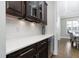 Elegant bar area with wine storage, custom cabinetry, and quartz countertops at 832 Mountain Vista Ln, Cary, NC 27519