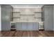 Home bar with stylish backsplash, floating shelves, beverage refrigerators, and plenty of storage at 832 Mountain Vista Ln, Cary, NC 27519