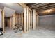 Unfinished basement with framed walls and concrete floor, lit by a single light bulb, plus an electric keyboard at 832 Mountain Vista Ln, Cary, NC 27519