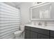 Bathroom featuring a shower curtain, vanity with quartz countertop and framed mirror at 832 Mountain Vista Ln, Cary, NC 27519