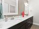 Bathroom featuring double sink vanity with quartz countertop and unique grey tile backsplash at 832 Mountain Vista Ln, Cary, NC 27519