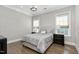 Comfortable bedroom with neutral colors, tray ceiling, and two windows at 832 Mountain Vista Ln, Cary, NC 27519