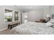Cozy bedroom with a patterned comforter, bench, and a window at 832 Mountain Vista Ln, Cary, NC 27519