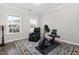 A bedroom with exercise equipment, a comfy chair, carpet and two windows at 832 Mountain Vista Ln, Cary, NC 27519