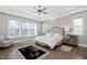 Spacious bedroom with large windows, tray ceiling, ceiling fan, and hardwood floors at 832 Mountain Vista Ln, Cary, NC 27519