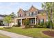 Charming brick home featuring a manicured lawn with tasteful landscaping and covered front porch at 832 Mountain Vista Ln, Cary, NC 27519