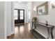 Grand foyer with dark wood floors, double doors, decorative mirror, and gray accent table at 832 Mountain Vista Ln, Cary, NC 27519