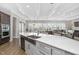 Large kitchen island with stainless steel sink and white cabinets, flowing into living area at 832 Mountain Vista Ln, Cary, NC 27519