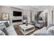 Elegant living room featuring a modern fireplace, TV, seating, and staircase at 832 Mountain Vista Ln, Cary, NC 27519