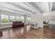 Open living area featuring hardwood floors, large windows, and a seating area with coffered ceilings at 832 Mountain Vista Ln, Cary, NC 27519
