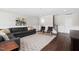 Spacious living room boasts a large sectional sofa, stylish area rug, and hardwood floors at 832 Mountain Vista Ln, Cary, NC 27519
