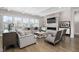 Bright living room with hardwood floors, a tiled fireplace, a mounted TV, and neutral furnishings at 832 Mountain Vista Ln, Cary, NC 27519