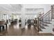 Open-concept living area featuring hardwood floors, an eat-in kitchen, a living room, and stairs at 832 Mountain Vista Ln, Cary, NC 27519