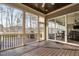 Screened-in patio with wooden floor and sliding glass doors leading to an outdoor view, plus a grill at 832 Mountain Vista Ln, Cary, NC 27519