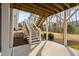 Covered patio featuring wood ceiling, concrete floor and stairs leading to backyard at 832 Mountain Vista Ln, Cary, NC 27519