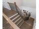 An open staircase with wood steps and black metal railing leads to the lower level at 832 Mountain Vista Ln, Cary, NC 27519