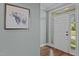 Bright foyer featuring hardwood floors and a sidelight window by the entry door at 8512 Parlange Woods Ln, Wake Forest, NC 27587