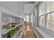 Hallway that leads to a dining area, featuring built-in shelving and natural light at 8512 Parlange Woods Ln, Wake Forest, NC 27587