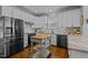 Modern kitchen with stainless steel appliances, white cabinets, and wood floors at 8512 Parlange Woods Ln, Wake Forest, NC 27587