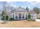 Charming white home with covered porch, columns, mature landscaping, and inviting curb appeal at 862 Legacy Falls S Dr, Chapel Hill, NC 27517