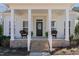 Inviting front porch with brick steps, decorative chairs, and black front door at 862 Legacy Falls S Dr, Chapel Hill, NC 27517