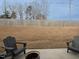 A backyard patio with two Adirondack chairs and a fire pit for outdoor relaxation at 8630 Kenridge Ln, Fuquay Varina, NC 27526