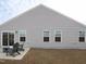 Exterior view of backyard featuring a concrete patio and chairs, great for outdoor living at 8630 Kenridge Ln, Fuquay Varina, NC 27526