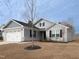 Charming single-story home with gray siding, stone accents, and well-maintained front yard at 8630 Kenridge Ln, Fuquay Varina, NC 27526