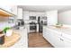 Modern kitchen featuring stainless steel appliances, granite countertops, and white cabinetry at 8630 Kenridge Ln, Fuquay Varina, NC 27526
