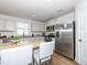 Modern kitchen featuring granite countertops, stainless steel appliances, and a breakfast bar at 8630 Kenridge Ln, Fuquay Varina, NC 27526