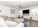 Bright living room with comfortable seating, modern decor, ceiling fan and plenty of natural light at 8630 Kenridge Ln, Fuquay Varina, NC 27526