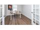 Home office with hardwood floors, modern desk, and natural light from a window at 8630 Kenridge Ln, Fuquay Varina, NC 27526
