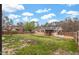 Expansive backyard featuring green lawn, mature trees, fencing, and a glimpse of the home's exterior at 902 Long Ave, Garner, NC 27529