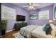 Inviting bedroom with modern décor, wood floors, a comfortable bed, and ample natural light at 902 Long Ave, Garner, NC 27529