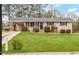 Charming single-story home with brick facade, manicured lawn, mature landscaping, and a welcoming front entrance at 902 Long Ave, Garner, NC 27529