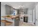 Updated kitchen with sleek gray cabinets, modern appliances, breakfast bar, and trendy tile flooring at 902 Long Ave, Garner, NC 27529